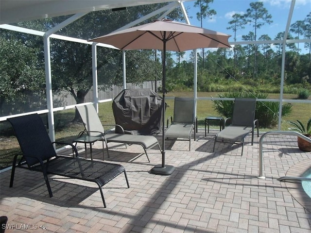 902 Mcarthur Ave, Lehigh Acres, FL 33936 - view of patio featuring a lanai and a grill
