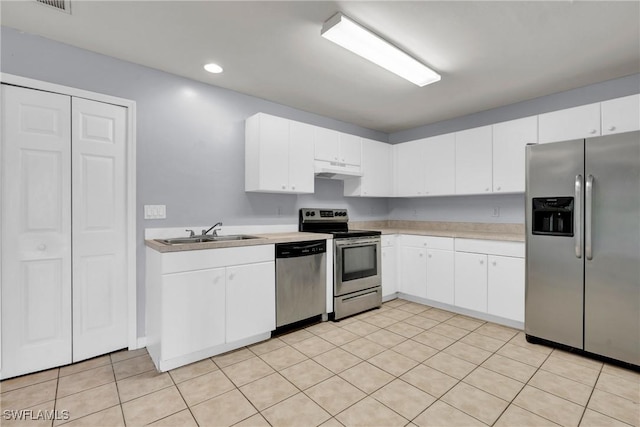 4508/4510 30th St SW, Lehigh Acres, FL 33973 - kitchen with stainless steel appliances, light countertops, recessed lighting, white cabinets, and light tile patterned floors