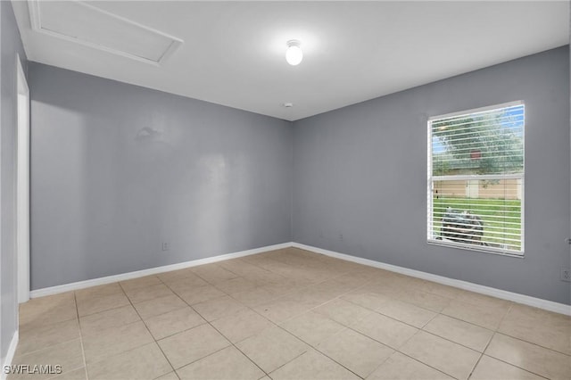 4508/4510 30th St SW, Lehigh Acres, FL 33973 - empty room with attic access, healthy amount of natural light, and light tile patterned flooring