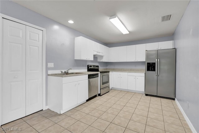 4508/4510 30th St SW, Lehigh Acres, FL 33973 - kitchen with appliances with stainless steel finishes, light countertops, white cabinetry, under cabinet range hood, and recessed lighting