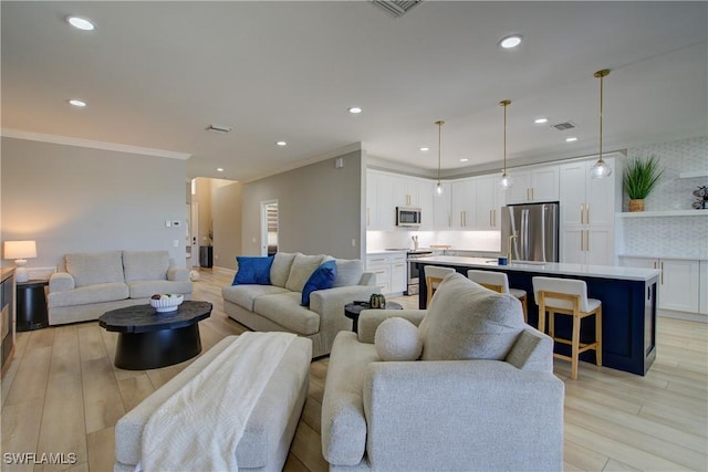 28601 Firenze Way Unit 102, Bonita Springs, FL 34135 - living area featuring ornamental molding, light wood-type flooring, and recessed lighting