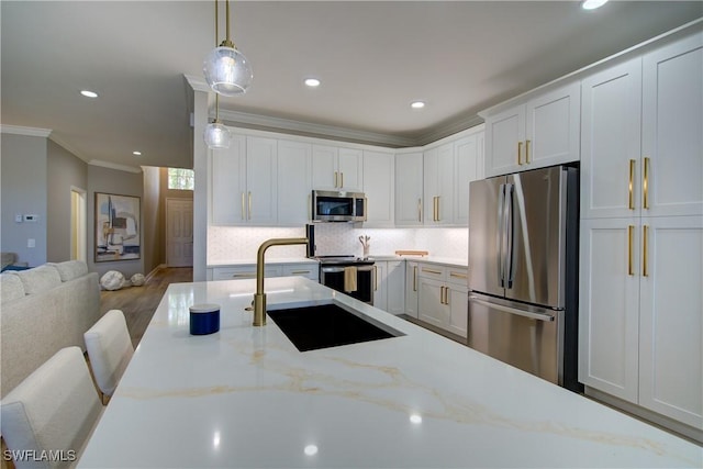 28601 Firenze Way Unit 102, Bonita Springs, FL 34135 - kitchen with appliances with stainless steel finishes, ornamental molding, decorative light fixtures, white cabinetry, and recessed lighting