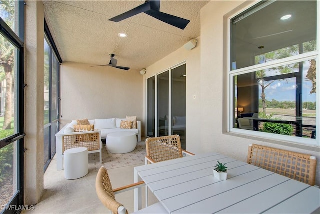 28601 Firenze Way Unit 102, Bonita Springs, FL 34135 - sunroom / solarium featuring a ceiling fan, outdoor dining space, and an outdoor living space