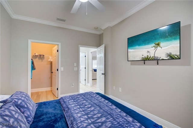 28601 Firenze Way Unit 102, Bonita Springs, FL 34135 - bedroom with ornamental molding, a ceiling fan, and a walk in closet