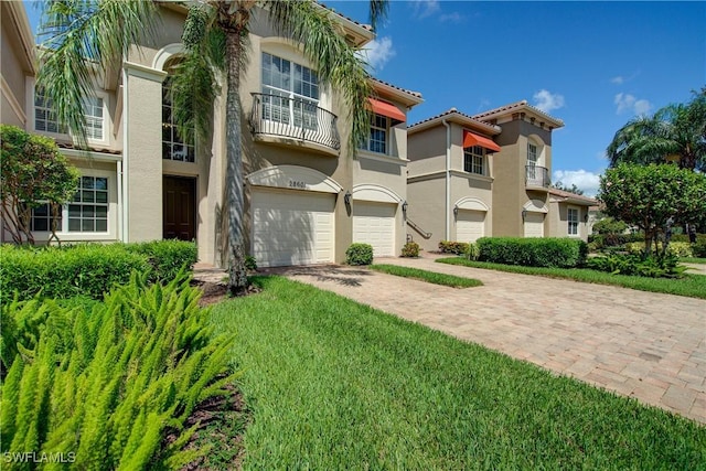 28601 Firenze Way Unit 102, Bonita Springs, FL 34135 - view of building exterior with a garage and decorative driveway