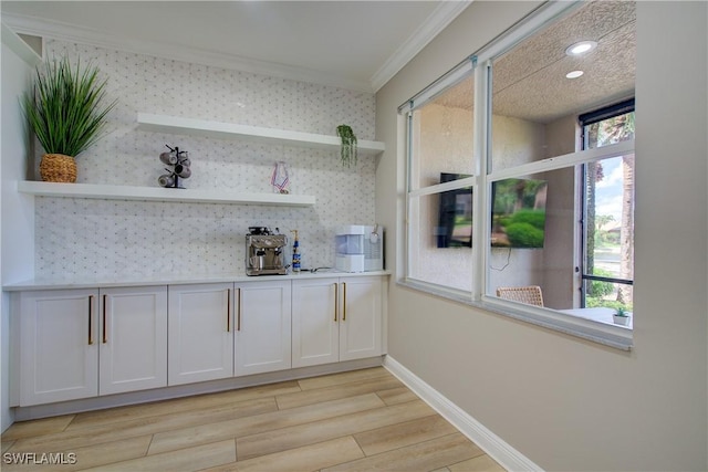 28601 Firenze Way Unit 102, Bonita Springs, FL 34135 - bar featuring crown molding, light wood finished floors, and recessed lighting