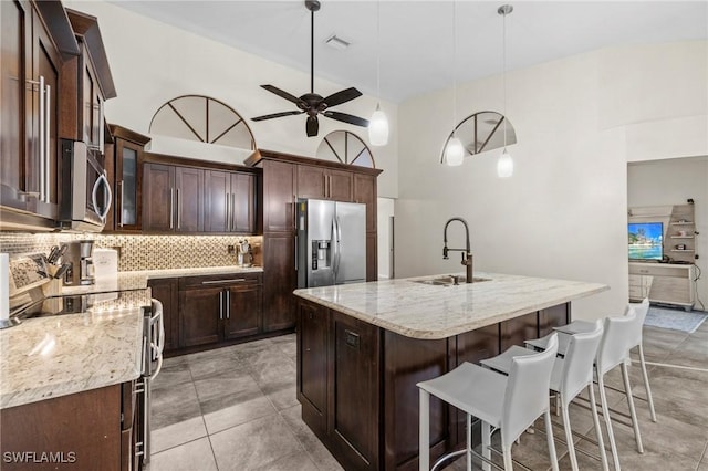 17971 Bermuda Dunes Dr, Fort Myers, FL 33967 - kitchen featuring appliances with stainless steel finishes, tasteful backsplash, a ceiling fan, and light stone counters