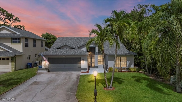 17971 Bermuda Dunes Dr, Fort Myers, FL 33967 - view of front facade featuring a garage, concrete driveway, a shingled roof, a front yard, and stucco siding