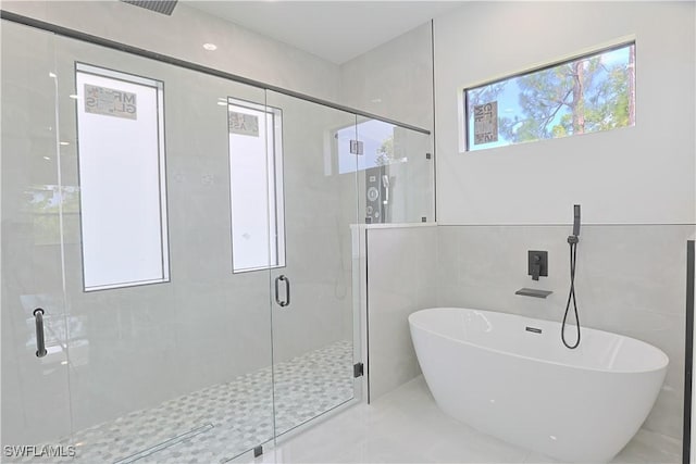 1803 Venice Ave N, Lehigh Acres, FL 33971 - bathroom with a freestanding tub and a stall shower