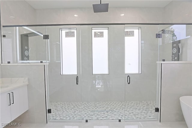 1803 Venice Ave N, Lehigh Acres, FL 33971 - full bathroom featuring a freestanding bath, vanity, a stall shower, and plenty of natural light