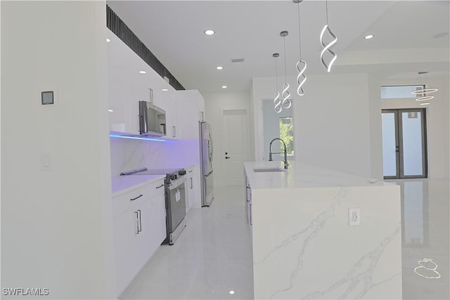 1803 Venice Ave N, Lehigh Acres, FL 33971 - kitchen with appliances with stainless steel finishes, modern cabinets, white cabinetry, an island with sink, and recessed lighting