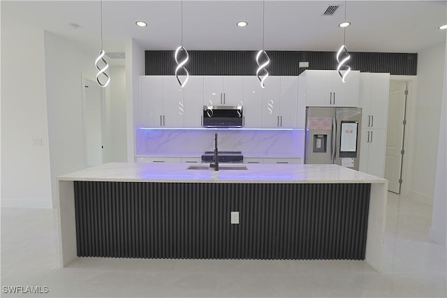 1803 Venice Ave N, Lehigh Acres, FL 33971 - kitchen with stainless steel appliances, a spacious island, white cabinetry, pendant lighting, and recessed lighting