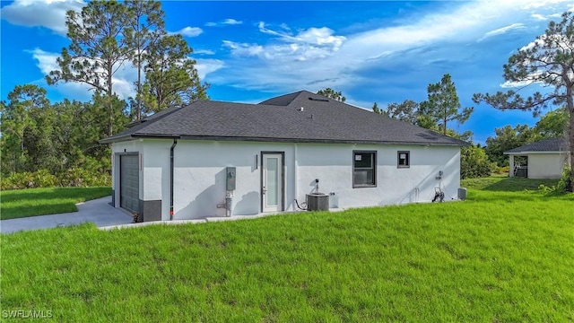 1803 Venice Ave N, Lehigh Acres, FL 33971 - rear view of property with stucco siding, a yard, and a shingled roof