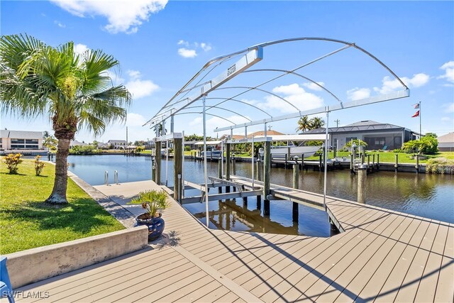 4622 SW 10th Ave, Cape Coral, FL 33914 - dock area with boat lift, a water view, a lawn, and a residential view