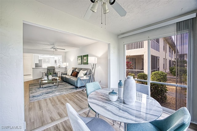 16251 Dublin Cir Unit F101, Fort Myers, FL 33908 - dining space with a ceiling fan, wood finished floors, a textured wall, and a textured ceiling