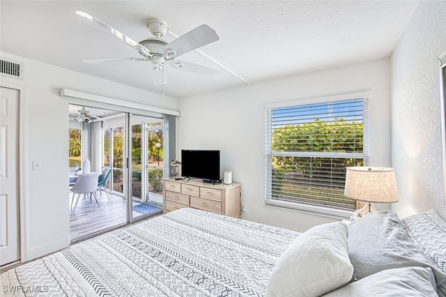 16251 Dublin Cir Unit F101, Fort Myers, FL 33908 - bedroom with access to outside, multiple windows, ceiling fan, and wood finished floors