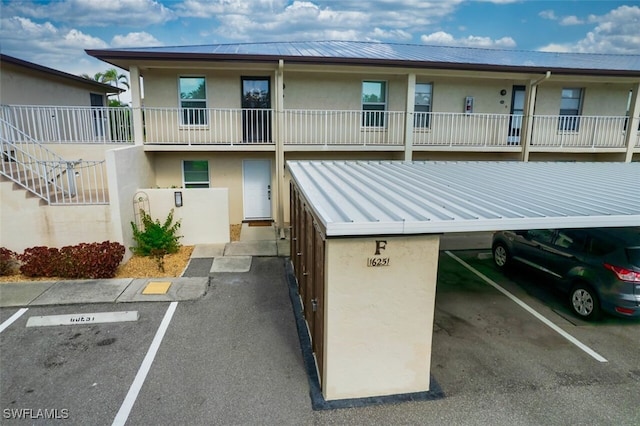 16251 Dublin Cir Unit F101, Fort Myers, FL 33908 - view of building exterior featuring uncovered parking