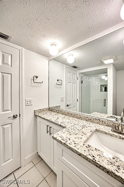 16251 Dublin Cir Unit F101, Fort Myers, FL 33908 - full bath featuring tile patterned flooring, vanity, a stall shower, and a textured ceiling