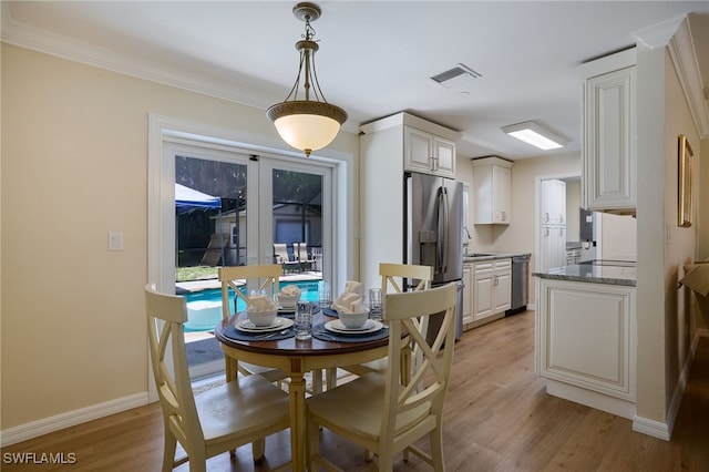 559 Woodruff St, North Fort Myers, FL 33903 - dining space featuring light wood finished floors and crown molding
