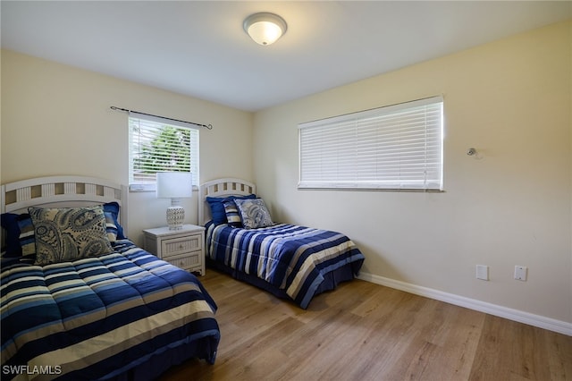559 Woodruff St, North Fort Myers, FL 33903 - bedroom with light wood-style flooring and baseboards