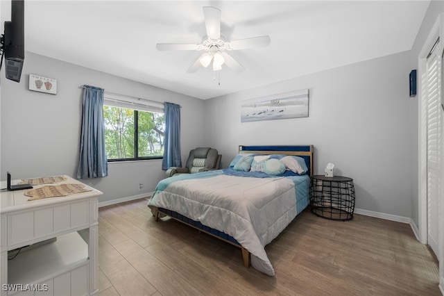 bedroom featuring wood finished floors and a ceiling fan