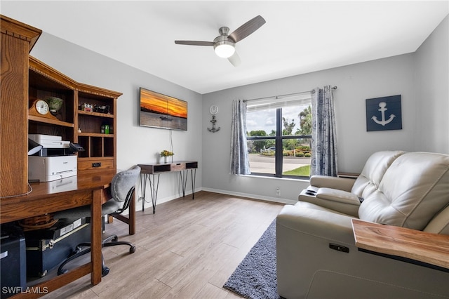 home office featuring light wood-style flooring and a ceiling fan