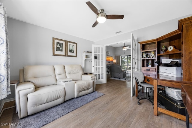 office featuring a ceiling fan, french doors, and light wood-style floors
