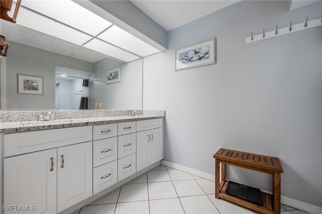 bathroom with double vanity and tile patterned flooring