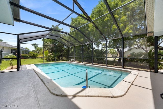 swimming pool with a patio area, glass enclosure, and a yard