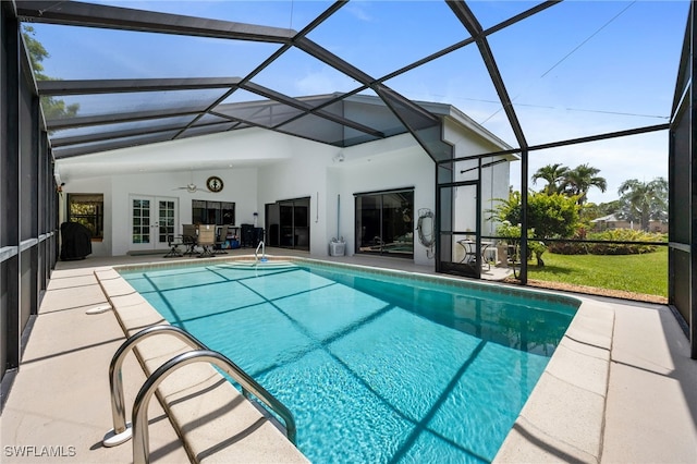 outdoor pool with french doors, a patio area, a lanai, and a ceiling fan