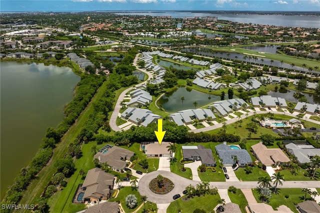 aerial view of property and surrounding area with nearby suburban area and a nearby body of water