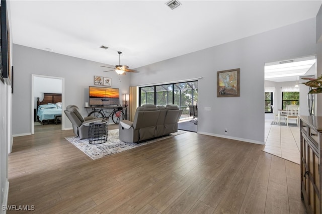 living area with ceiling fan and wood finished floors