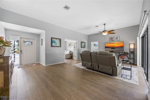 living room featuring wood finished floors and a ceiling fan
