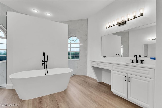 2313 SE 20th Pl, Cape Coral, FL 33990 - full bath with wood finished floors, a soaking tub, vanity, and a shower