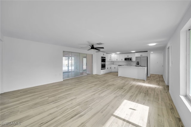 3307 Pinetree St, Port Charlotte, FL 33952 - unfurnished living room featuring light wood-style floors and a ceiling fan