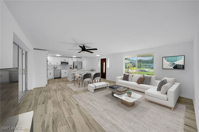 3307 Pinetree St, Port Charlotte, FL 33952 - living room with light wood finished floors, a ceiling fan, and recessed lighting