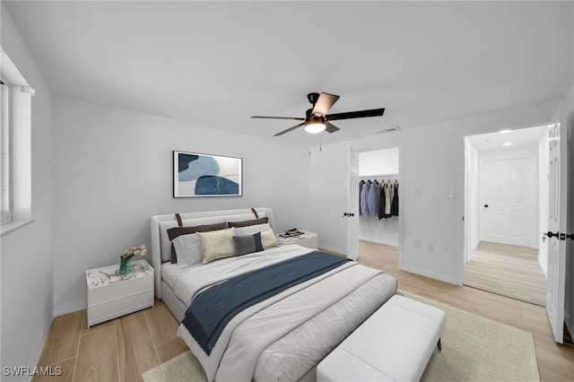 3307 Pinetree St, Port Charlotte, FL 33952 - bedroom with light wood-style flooring, ceiling fan, and a walk in closet