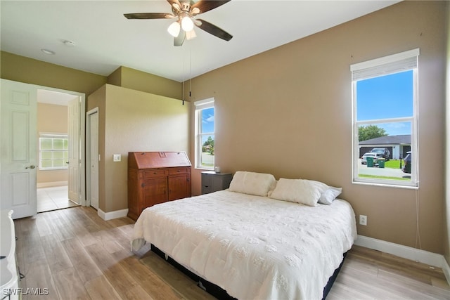 3271 Lemon Ln, Naples, FL 34120 - bedroom with light wood-style floors, multiple windows, and a ceiling fan