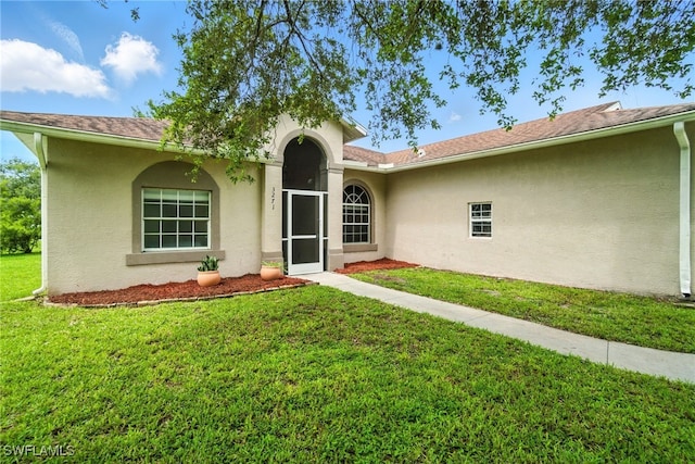 3271 Lemon Ln, Naples, FL 34120 - view of front facade featuring stucco siding and a front yard