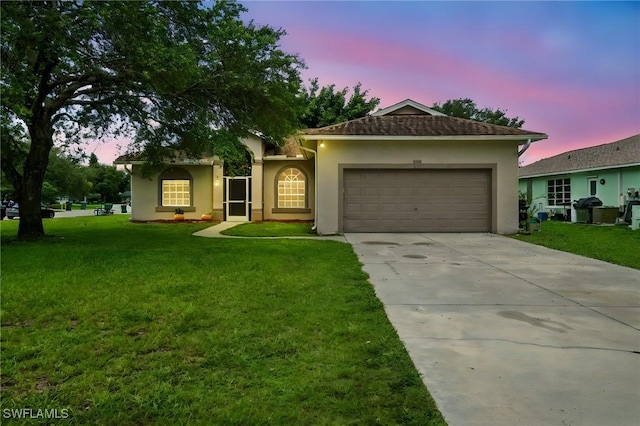 3271 Lemon Ln, Naples, FL 34120 - ranch-style house featuring an attached garage, concrete driveway, stucco siding, and a lawn