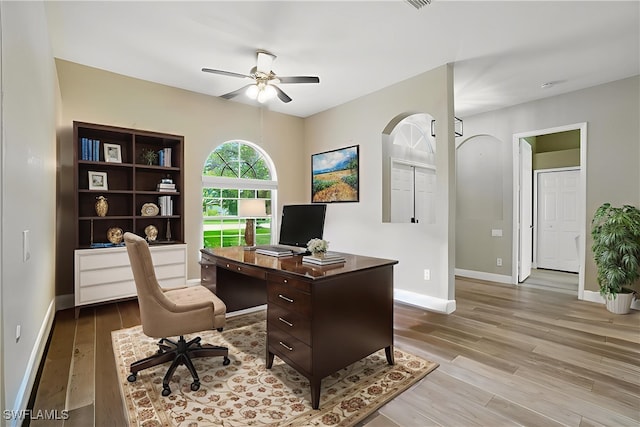 3271 Lemon Ln, Naples, FL 34120 - office space with a ceiling fan, wood finished floors, and arched walkways