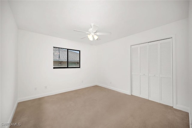 519 99th Ave N, Naples, FL 34108 - unfurnished bedroom featuring carpet, a closet, and a ceiling fan