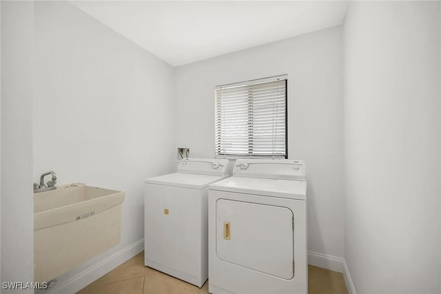 519 99th Ave N, Naples, FL 34108 - washroom with washer and clothes dryer and light tile patterned flooring