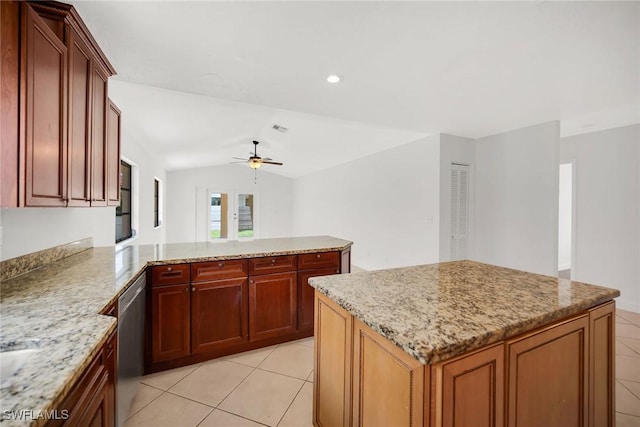 519 99th Ave N, Naples, FL 34108 - kitchen featuring ceiling fan, light tile patterned floors, a peninsula, light stone countertops, and lofted ceiling