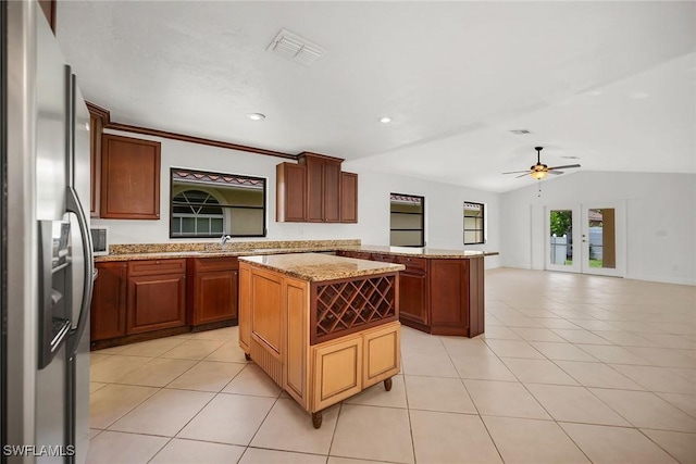 519 99th Ave N, Naples, FL 34108 - kitchen featuring stainless steel fridge with ice dispenser, a center island, light tile patterned floors, a peninsula, and recessed lighting