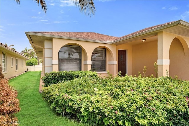 519 99th Ave N, Naples, FL 34108 - property entrance with stucco siding and a yard