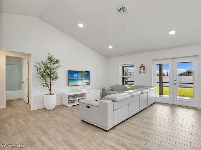 2405 Nelson Rd N, Cape Coral, FL 33993 - living area featuring vaulted ceiling, light wood-style flooring, recessed lighting, and french doors