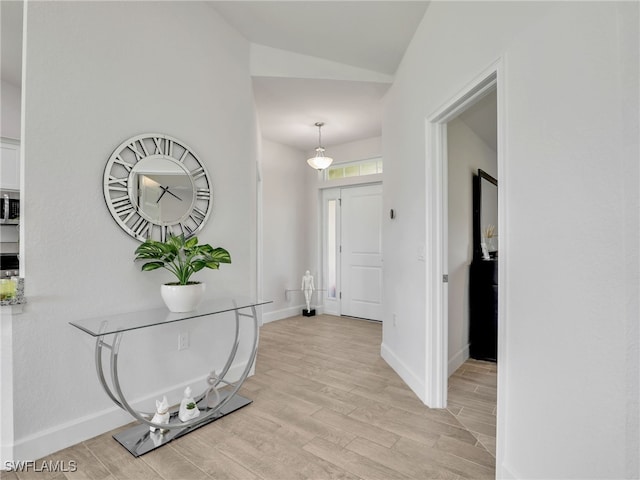 2405 Nelson Rd N, Cape Coral, FL 33993 - entrance foyer featuring lofted ceiling and light wood finished floors