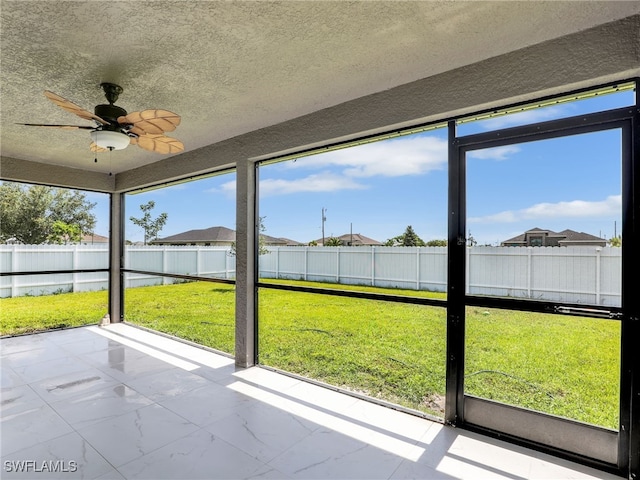 2405 Nelson Rd N, Cape Coral, FL 33993 - unfurnished sunroom with a ceiling fan and healthy amount of natural light