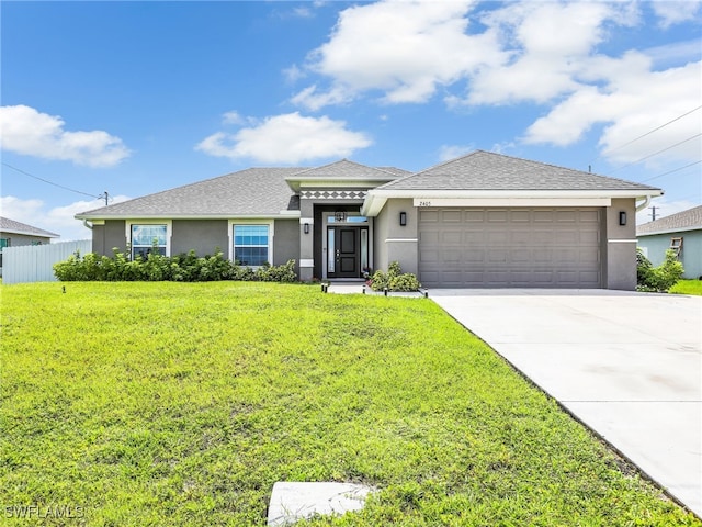 2405 Nelson Rd N, Cape Coral, FL 33993 - view of front of home featuring stucco siding, an attached garage, driveway, and a shingled roof